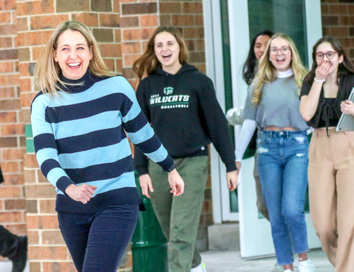 Novi Community School District Educator of the Year Hattie Maguire and several students react to the sight of the new Chevrolet Equinox that Feldman Automotive Group parked outside Novi High School March 2 as part of the reward for Maguire being Educator of the Year. Maguire received a free two-year lease on the new Equinox.